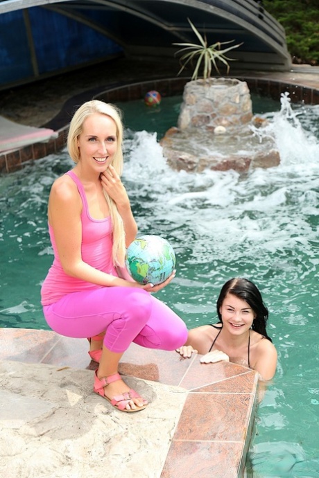 Cute lesbians Jenny Simons & Lucy Li toy each other's wet pussies poolside