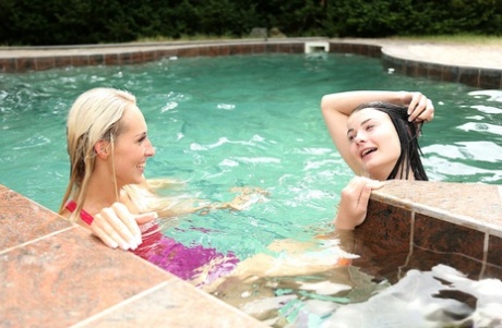 Cute lesbians Jenny Simons & Lucy Li toy each other's wet pussies poolside