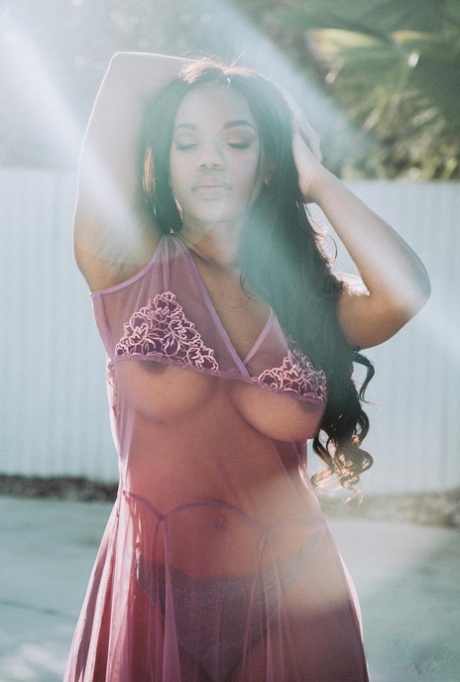 Beautiful black babe Selene teases with her big boobs while naked outdoors